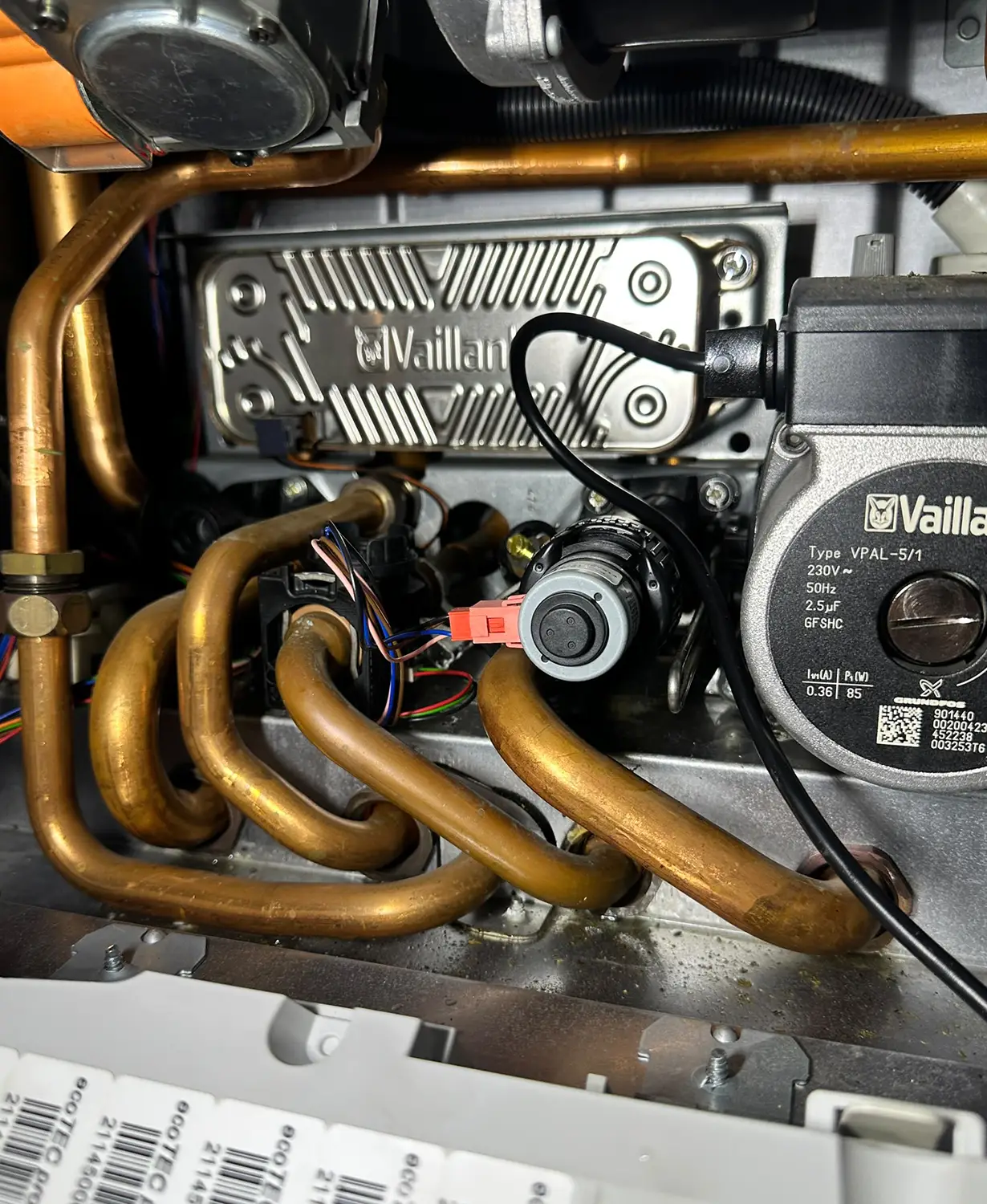 Close-up of internal boiler components being inspected during a professional gas boiler fault diagnosis and repair by J Copland Plumbing and Heating