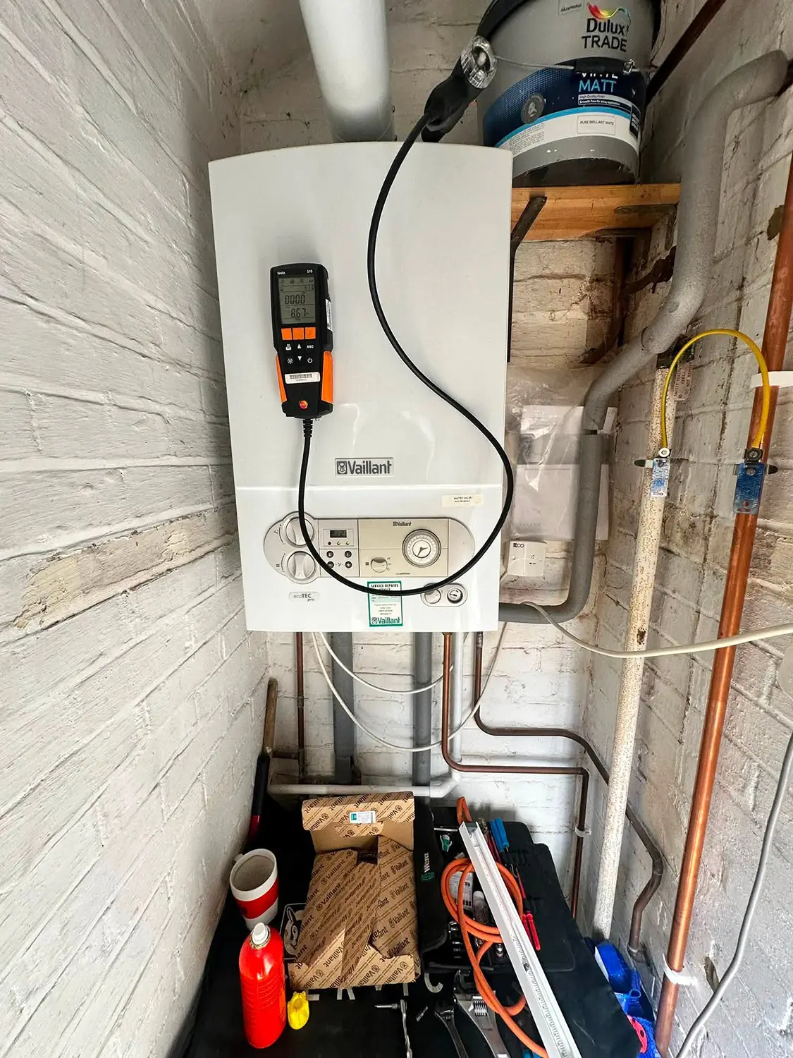 Boiler engineer testing the performance and safety of a home heating system during an annual boiler service by J Copland Plumbing and Heating