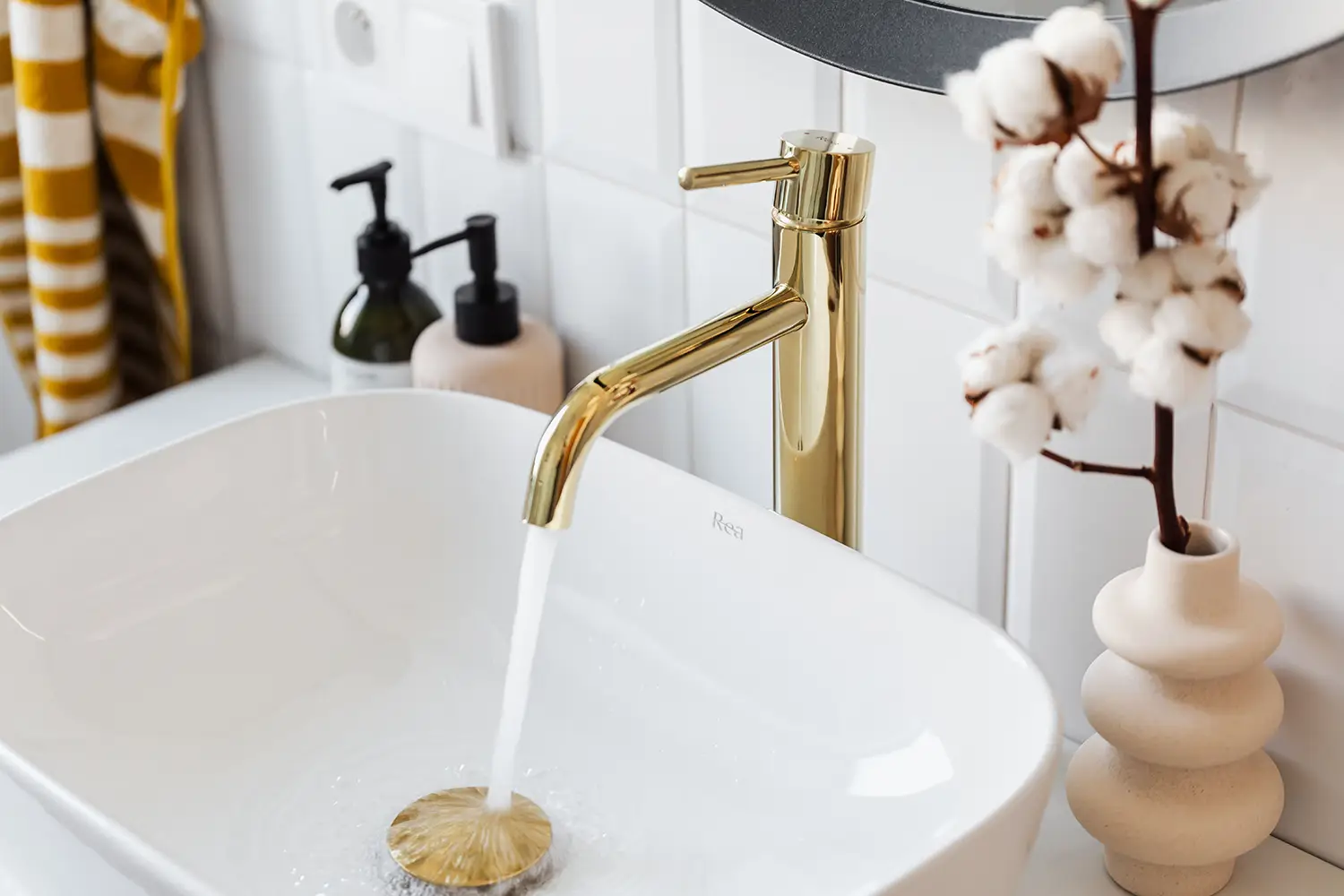 Close-up of a modern highly polish brass bathroom basin tap installed as part of a bathroom upgrade